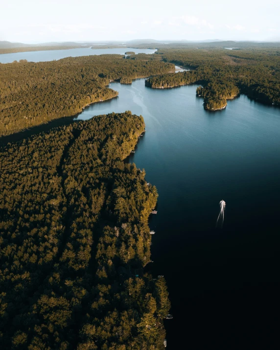 a small boat is sailing in the middle of a body of water