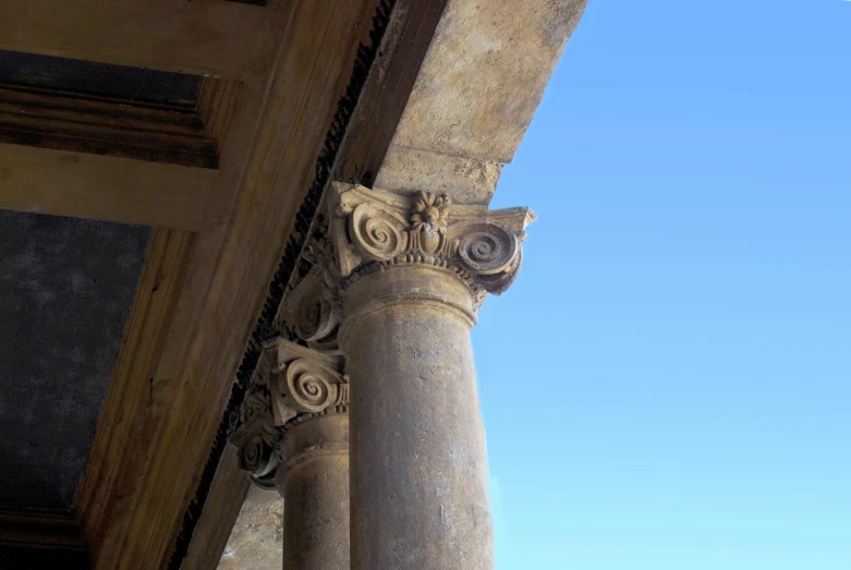 the bottom portion of the stone column is adorned with roses