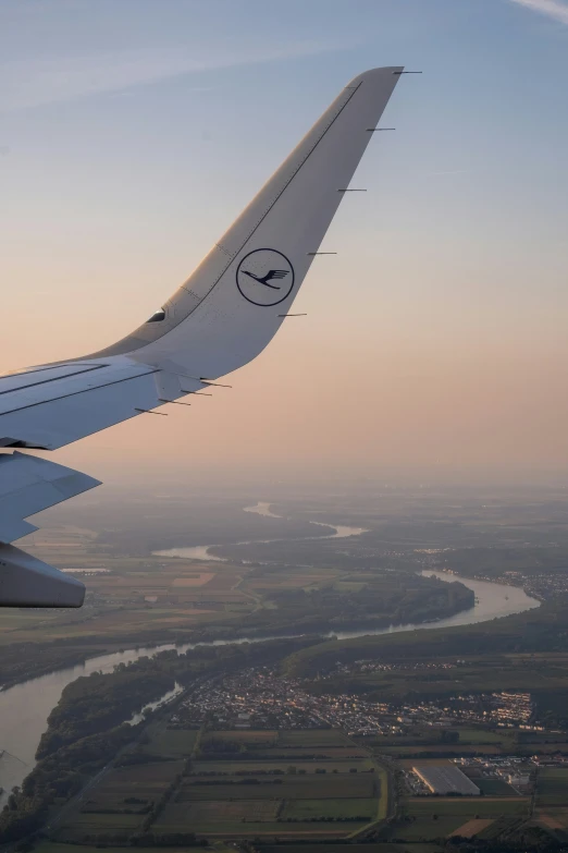 a view of an airplane wing with some other planes in the air