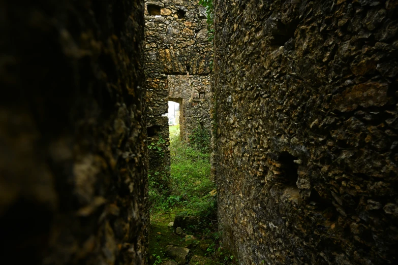 an empty alley leading to another building in the country