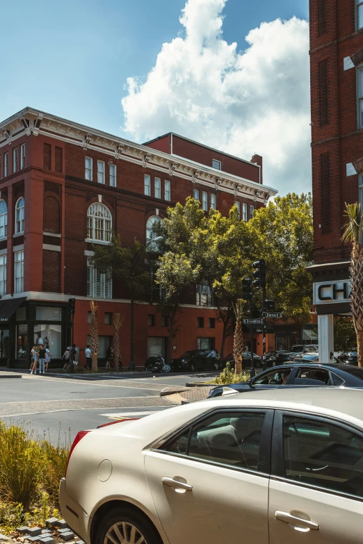 a white car parked in front of a brick building