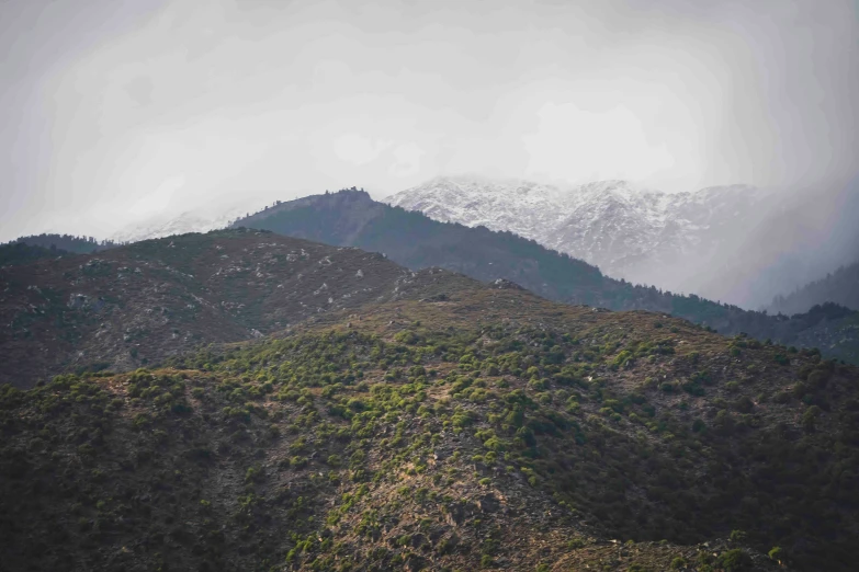 a very tall mountain range covered in snow