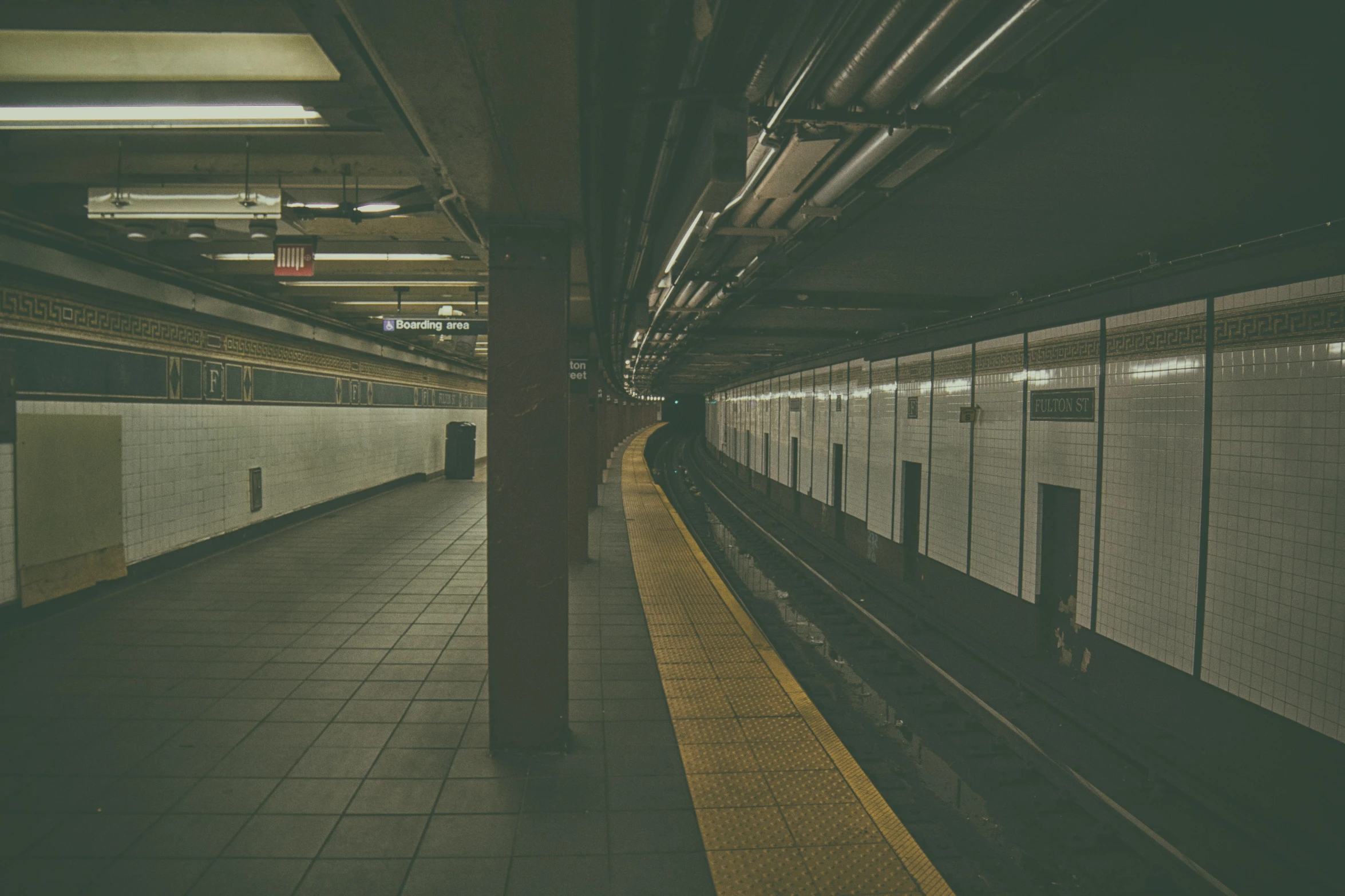 the subway station's tiled floor is dark and gloomy