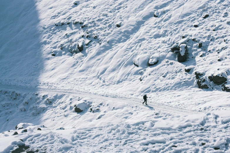 a person hiking up a snowy mountain on skis