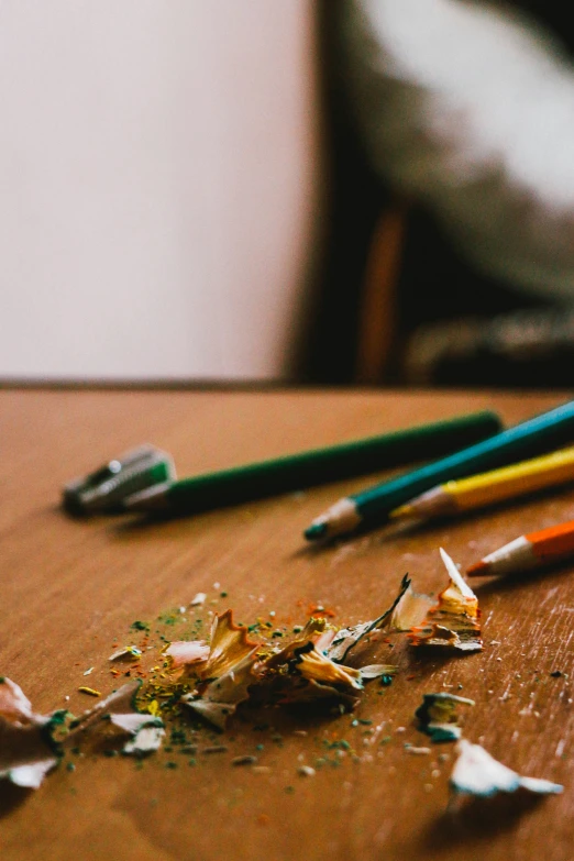 close up of three pencils on a table with broken one