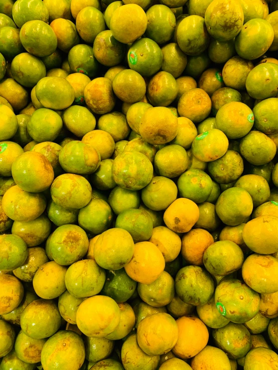 a pile of lemons is piled high with yellow fruit