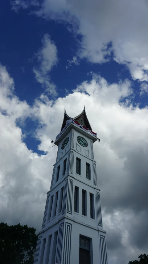 the tall tower has a clock displayed on it