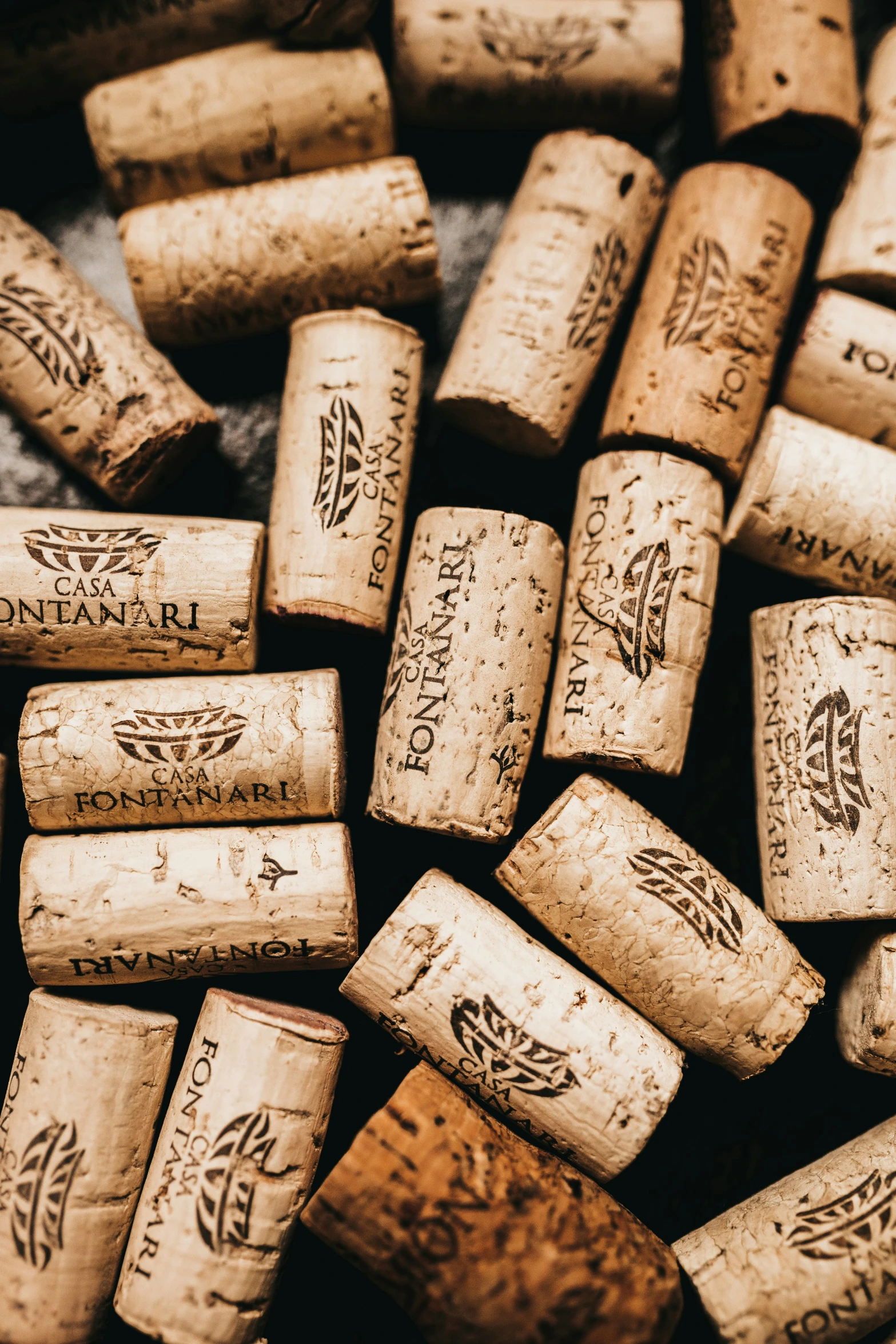 a pile of wine corks laid out in rows