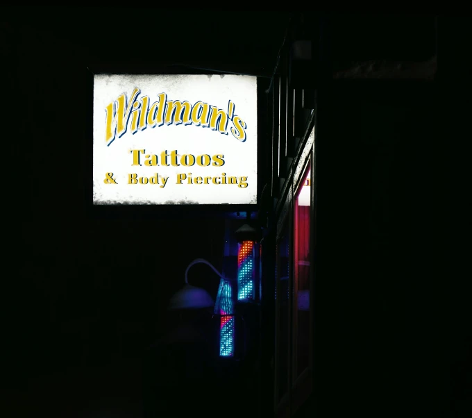 a restaurant sign lit up on a dark night