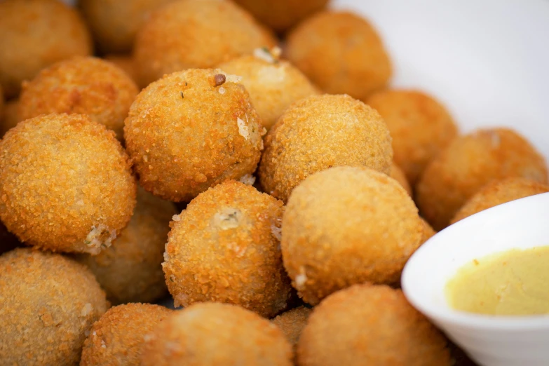 a bowl full of fried, cheeseburger holes sitting on a table