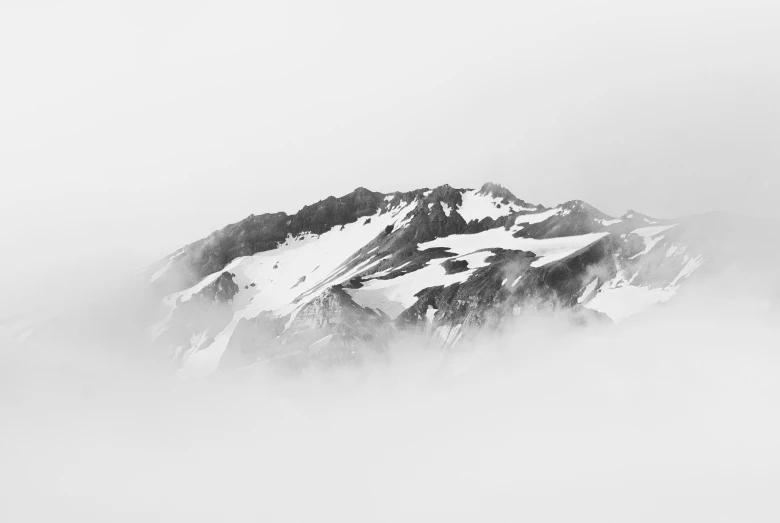 some snow covered mountains with a few clouds