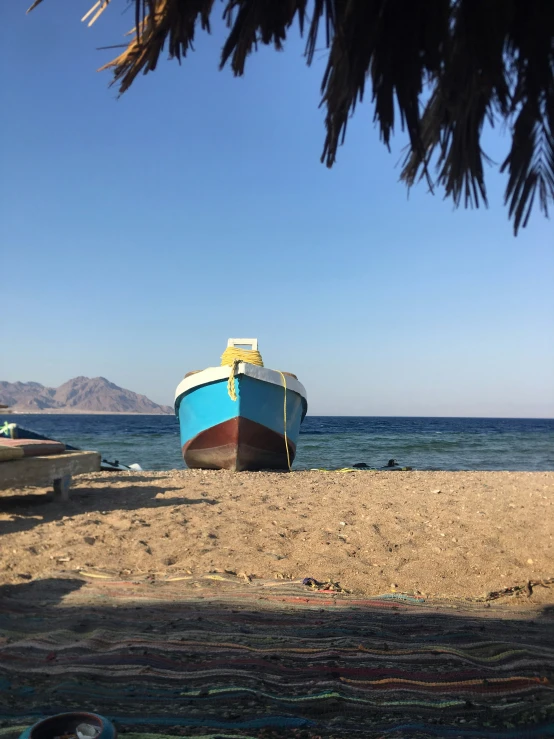 an image of boats sitting on the beach