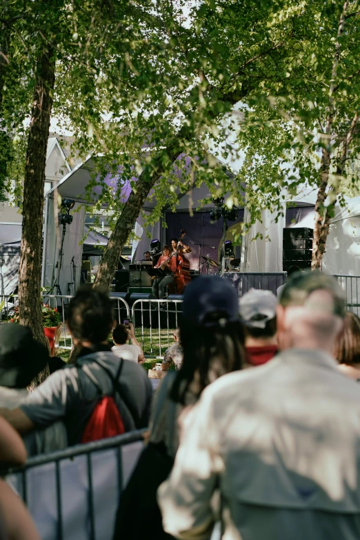 a crowd of people standing around a park