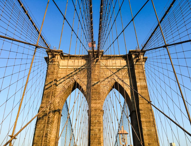 the view of a bridge from below with wires