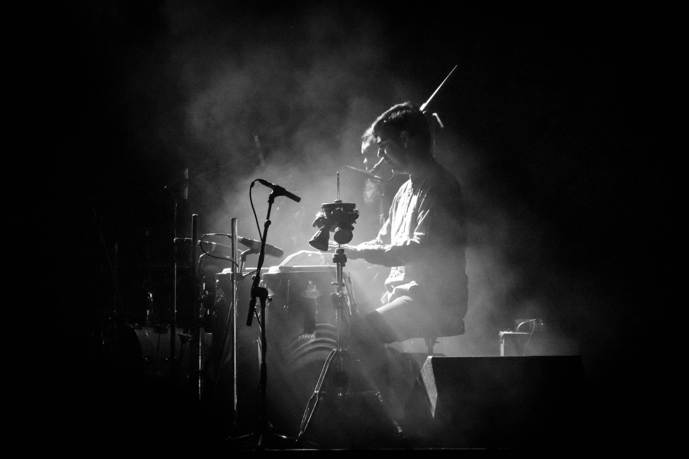 the man is singing on the stage while holding his guitar