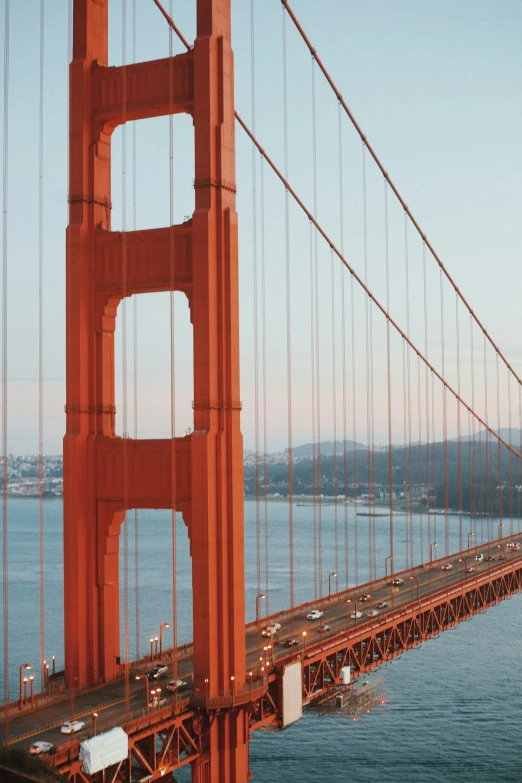 the view from a bridge shows cars driving over it