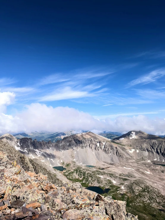 a large mountain with a few clouds in the sky