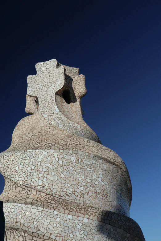 a close up po of a statue made of pebbles