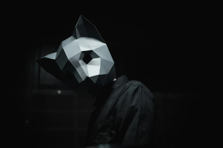a person with an animal mask in the dark