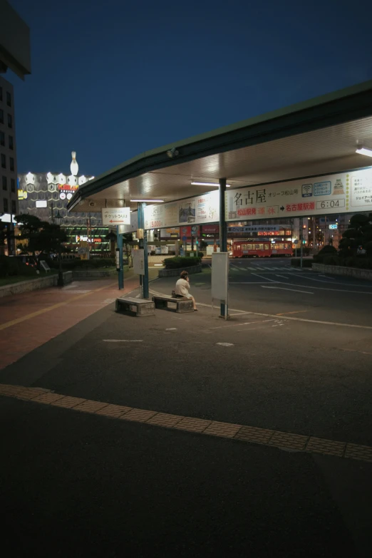 a bus station lit up at night in the dark