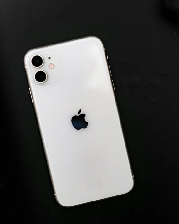 an iphone on a table, with a camera on the side