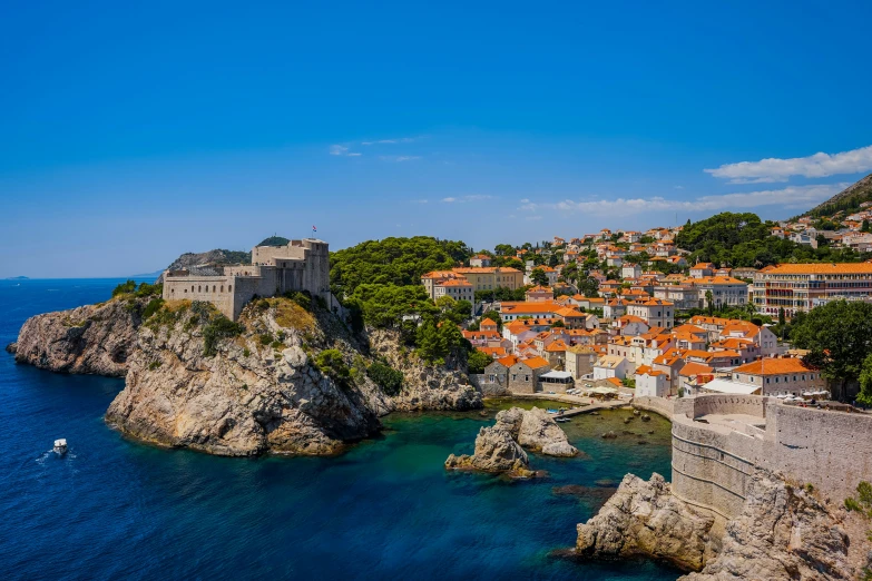 a view of a small village along the blue water