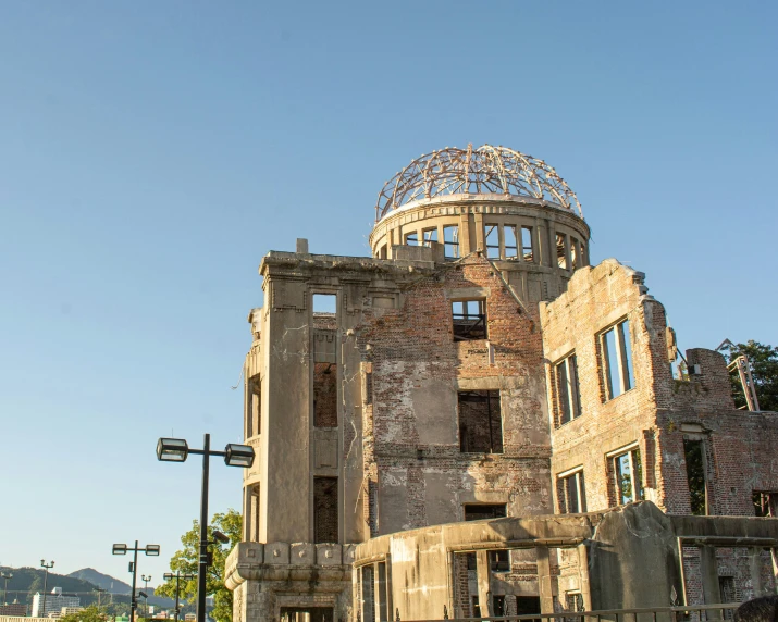 an old building with a glass dome sits under a blue sky