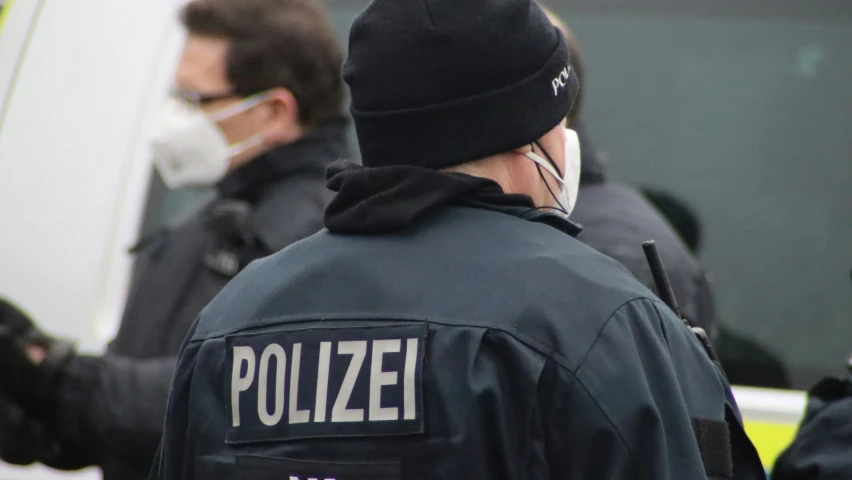 policemen standing outside and wearing masks on