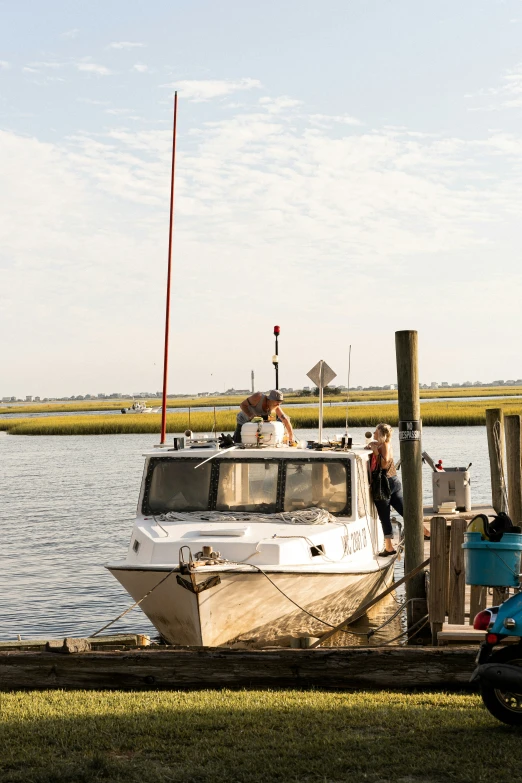 a boat docked on the shore next to the water