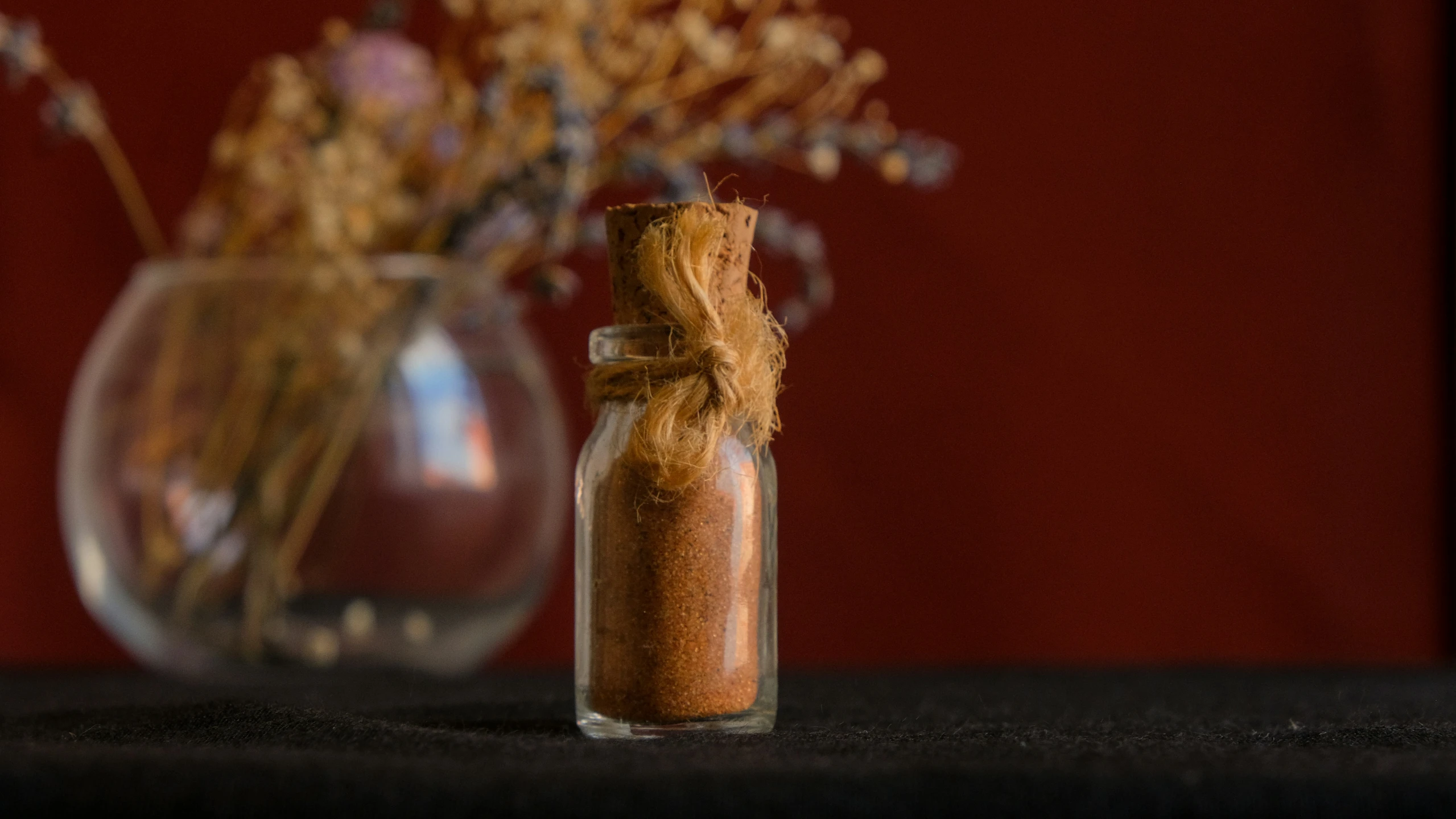 two vases sitting on a table with flowers in them