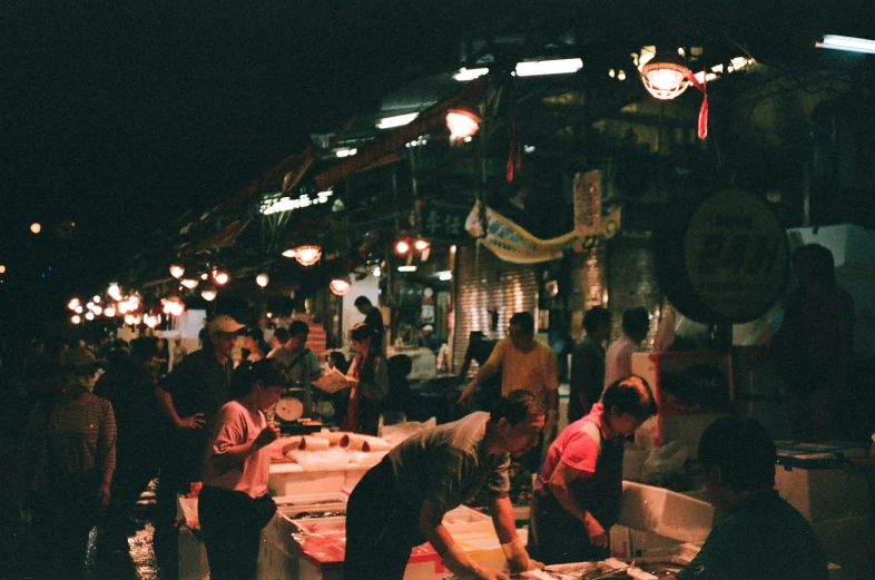 a dark and crowded area with various vendors