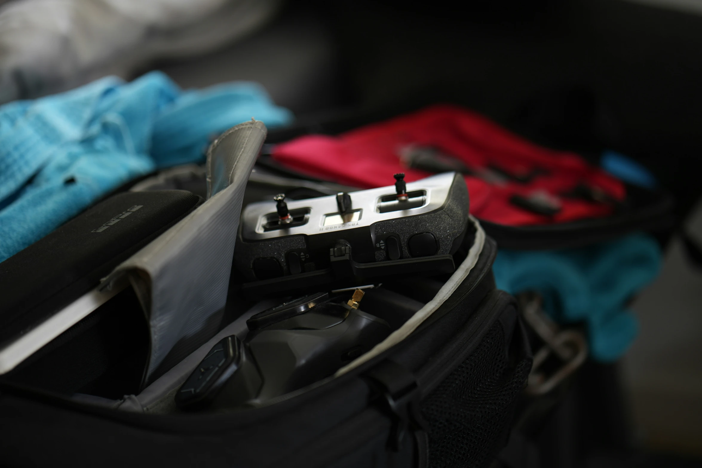 the inside of an open suitcase containing a cell phone