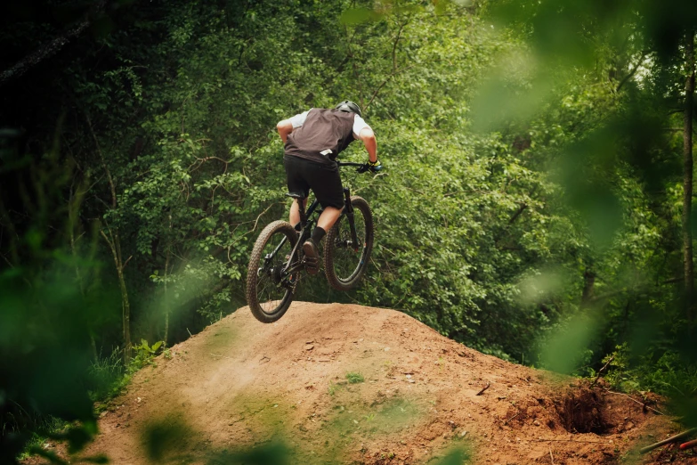 a person on a mountain bike is in the forest