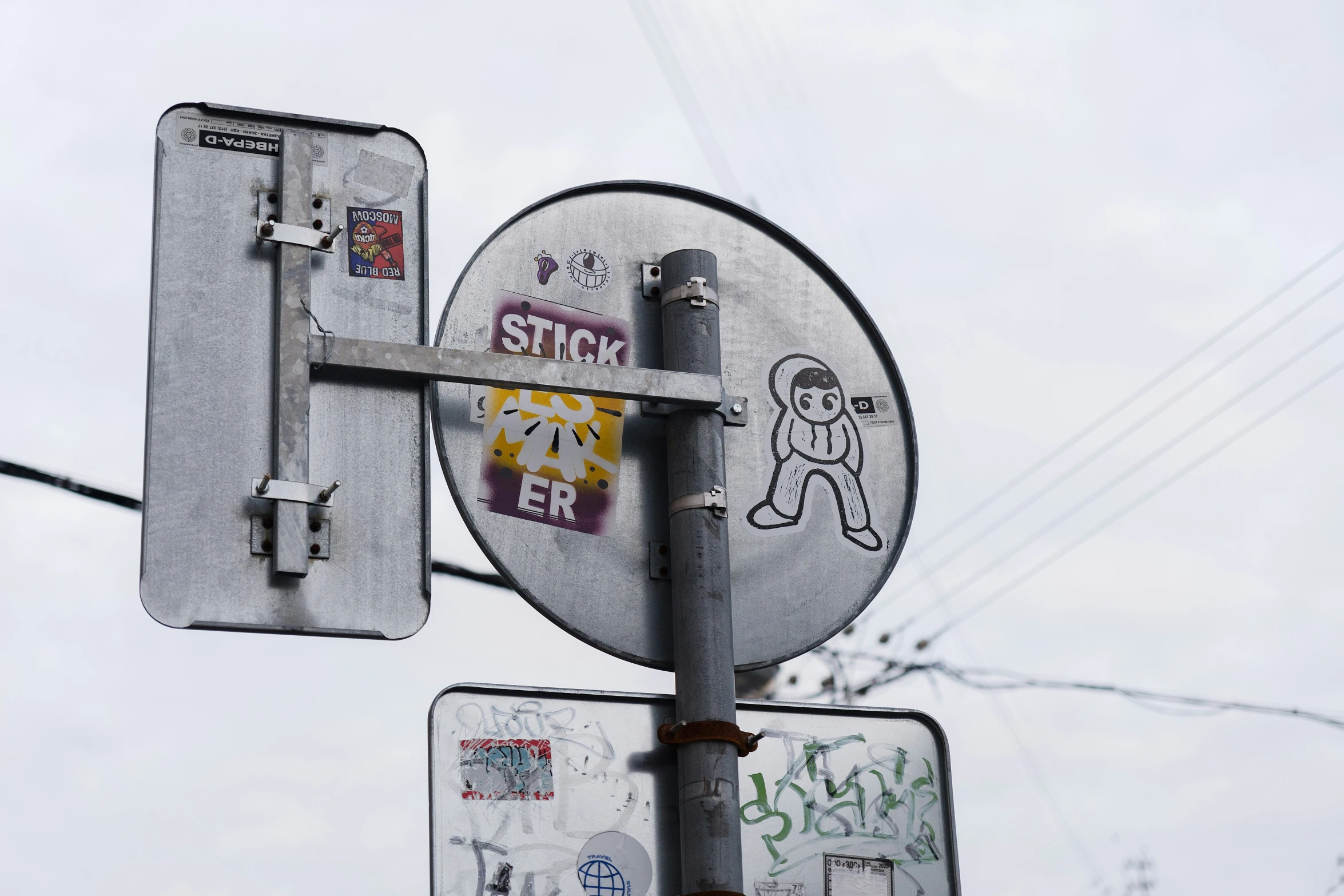 the close up of a street sign with graffiti