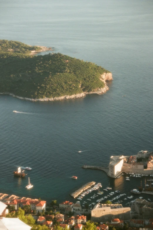 the harbor is surrounded by lush green hills