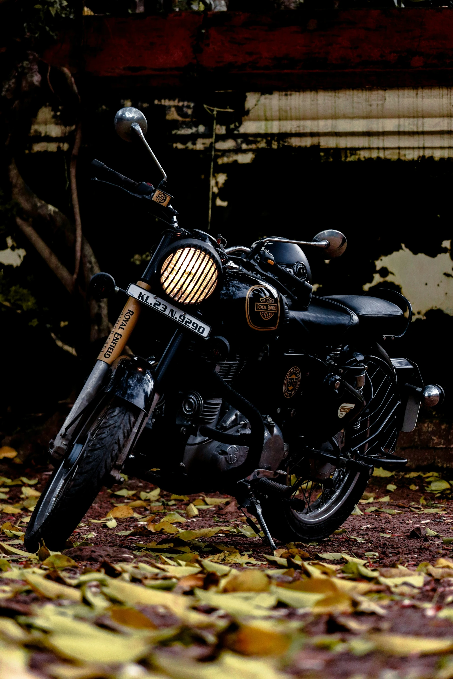 a motorcycle is parked in the shade under the trees