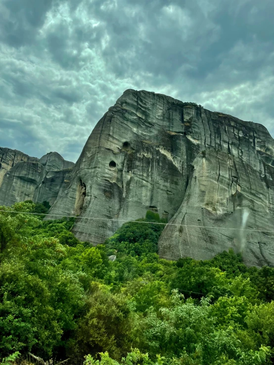 the rocky terrain looks like they're at the base of an enormous rock