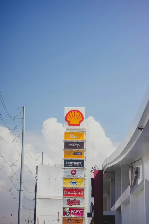 a shell gas station sign in front of a building