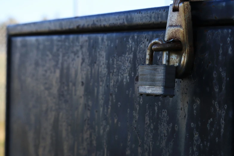 the lock is on a metal container and is attached to it