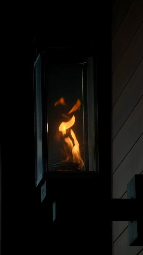 a window showing a smoke trail and a person in the reflection