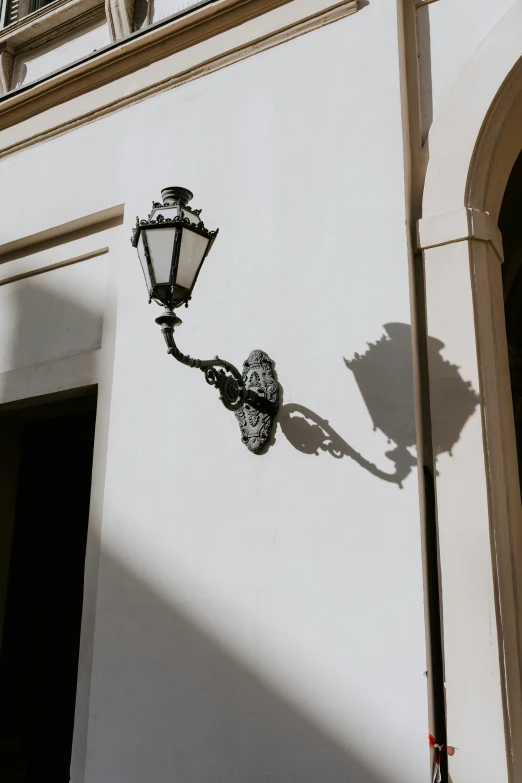 a street lamp and light on the outside of an apartment building