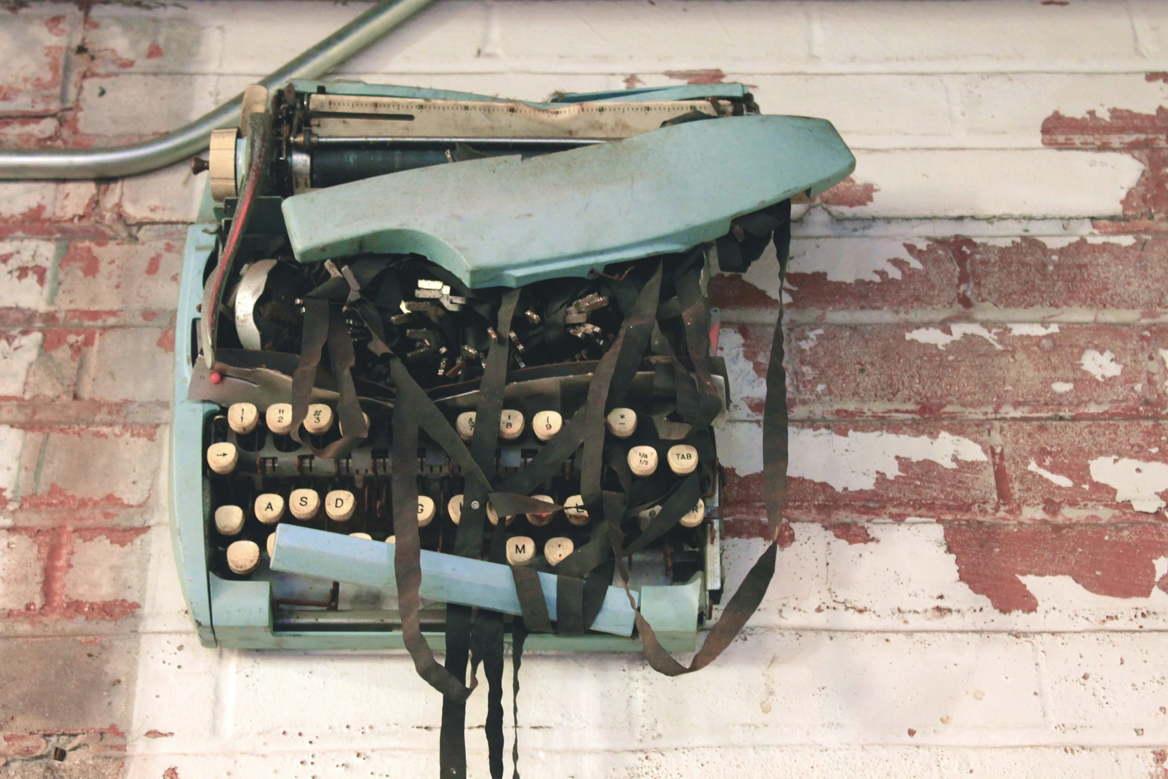 an old typewriter that was on display in front of a brick wall