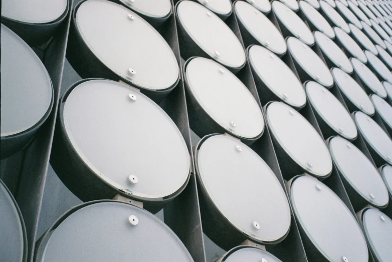 several rows of white barrels on display outside