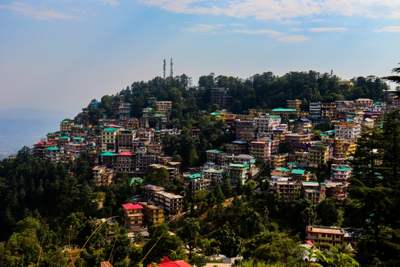 a small hill with many homes on top