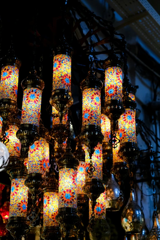 a wall full of lit lanterns in a store