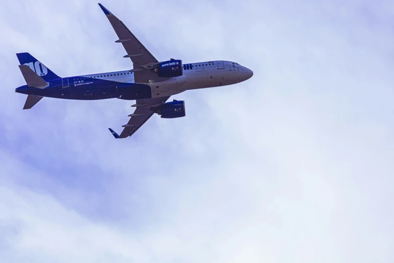 an airplane flying on its side in the sky