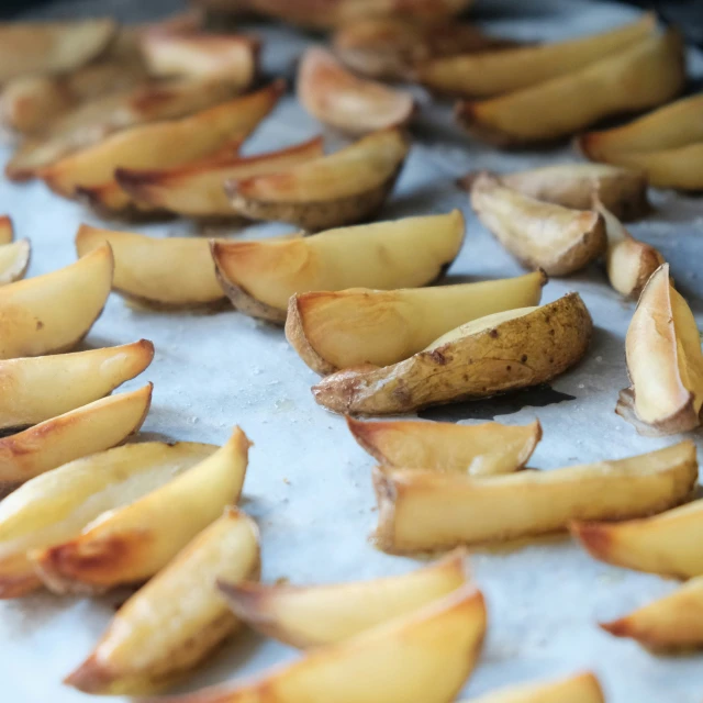 there are many pieces of fruit laying on the baking pan