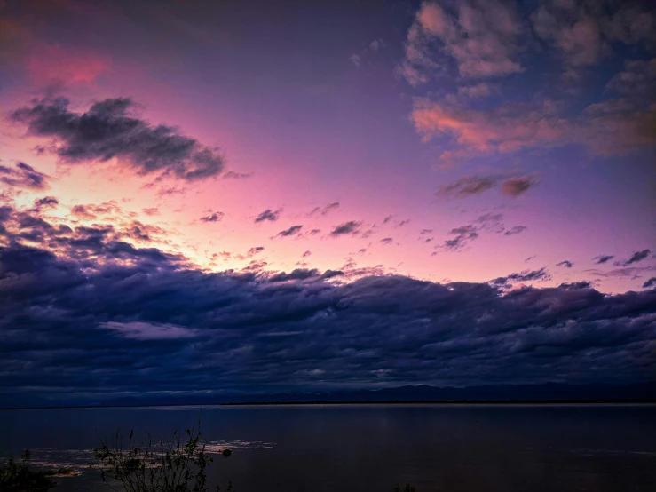 the clouds are in the pink and blue hue