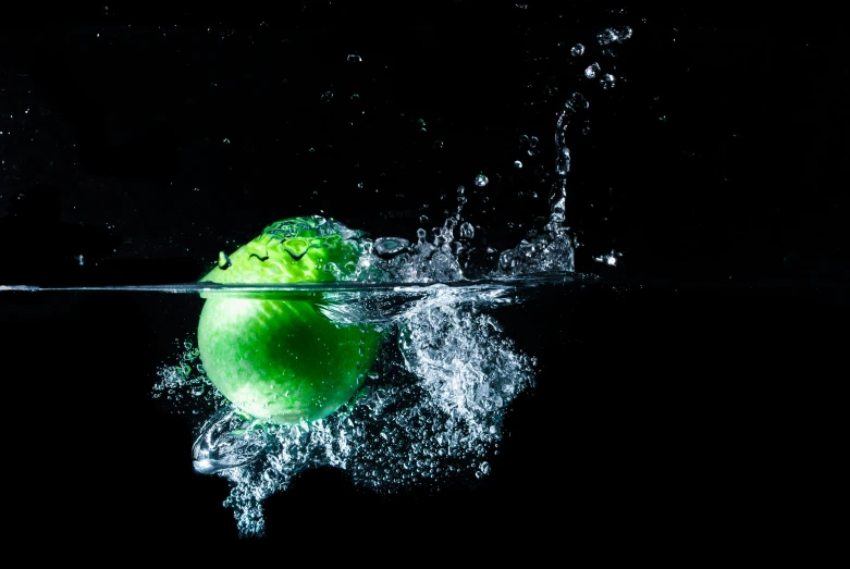 a ball of fruit that is floating in the water