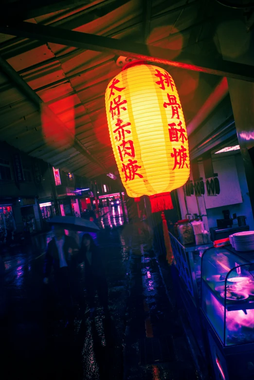 a chinese lantern in front of a window at a train station